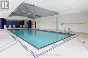 Toronto (Willowdale West) condo for rent - A large indoor swimming pool with a glass bottom and a white ceiling.