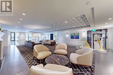 Toronto (Bay Street Corridor) condo for rent - A spacious living room with a patterned carpet and modern furniture.