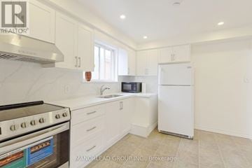 Toronto (Pleasant View) apartment for rent - A kitchen with white cabinets and a stove top oven.