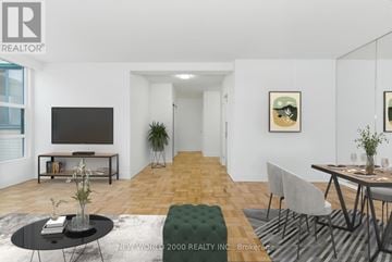 Toronto (Rosedale-Moore Park) condo for rent - A living room with a black coffee table and a grey sofa.