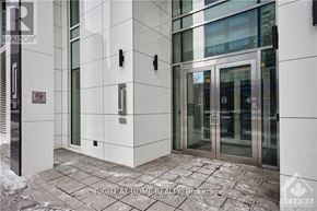 Ottawa condo for rent - A building entrance with a glass door and a metal handle.