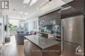 Ottawa condo for rent - A modern kitchen with stainless steel appliances and a glass island.
