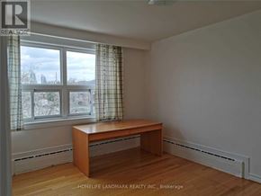 Toronto (Mimico) apartment for rent - A room with a desk and a window with curtains.