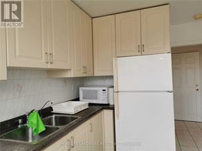 Toronto (Mimico) apartment for rent - A kitchen with a sink, microwave, and refrigerator.