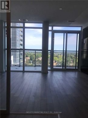 Toronto (Woburn) condo for rent - A room with a view of a cityscape through large windows.