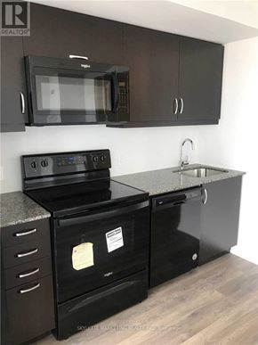 Toronto (Woburn) condo for rent - A black stove top oven with a microwave above it.