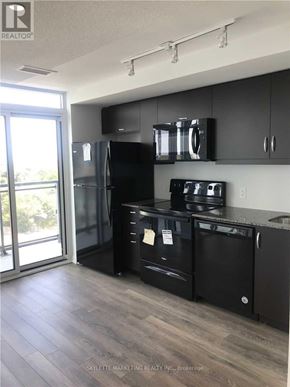 Toronto (Woburn) condo for rent - A kitchen with black appliances and cabinets.