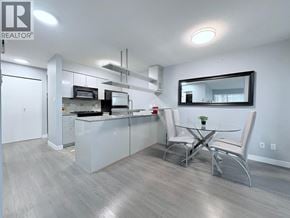 Vancouver apartment for rent - A modern kitchen with a dining table and chairs.