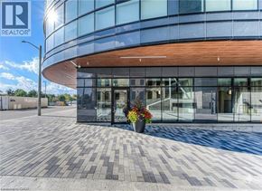Kitchener condo for rent - A modern building with a glass facade and a wooden entrance.