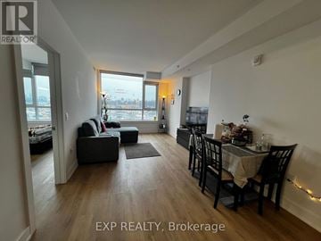 Ottawa condo for rent - A living room with a dining table and chairs.