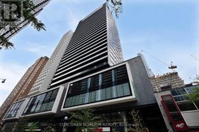 Toronto (Bay Street Corridor) condo for rent - A tall building with a sign that says "CORCORAN HORIZON REALTY Brokerage" in front of it.