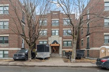 Ottawa apartment for rent - A brick building with a black truck parked in front.