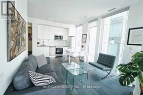 Toronto (Church-Yonge Corridor) condo for rent - A modern living room with a grey couch, a glass coffee table, and a large painting on the wall.
