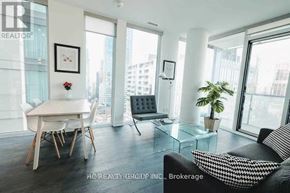 Toronto (Church-Yonge Corridor) condo for rent - A living room with a couch, a dining table and a plant.
