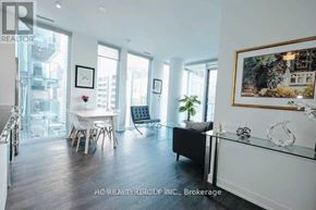 Toronto (Church-Yonge Corridor) condo for rent - A well-lit, spacious living room with a dining area and a view of the city.