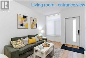 Oshawa (Samac) townhouse for rent - A living room with a grey couch and a white coffee table.