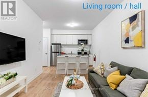 Oshawa (Samac) townhouse for rent - A living room with a grey couch and a television.