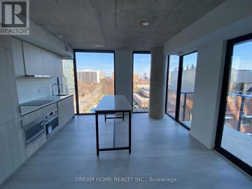 Toronto (Church-Yonge Corridor) condo for rent - A modern kitchen with a table and chairs in the foreground and a view of the city through the windows.