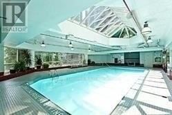 Toronto (Bay Street Corridor) condo for rent - A large indoor swimming pool with a wooden deck.