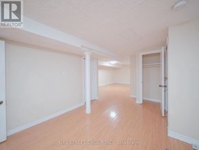 Brampton (Downtown Brampton) apartment for rent - A room with white walls and wooden flooring, with a door on the right side.