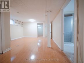 Brampton (Downtown Brampton) apartment for rent - A room with wooden flooring and white walls, with a window on the right side.