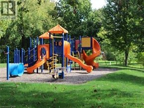Dundas townhouse for rent - A playground with a blue and orange slide and a yellow staircase.