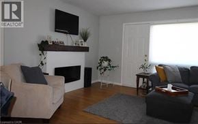Dundas townhouse for rent - A living room with a fireplace and a couch.