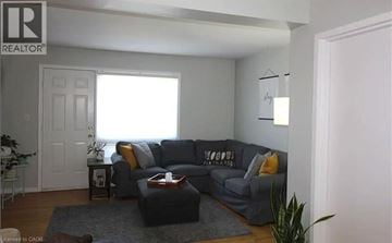 Dundas townhouse for rent - A living room with a grey couch and a coffee table.