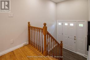Newmarket (Gorham-College Manor) apartment for rent - A room with a wooden staircase and white walls.
