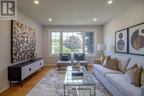 Newmarket (Gorham-College Manor) apartment for rent - A living room with a grey couch, a coffee table, and a large window.