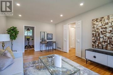Newmarket (Gorham-College Manor) apartment for rent - A living room with a glass coffee table and a white sofa.