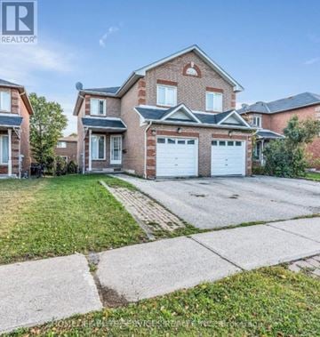 Toronto (Malvern) apartment for rent - A large brick house with a white garage door is for sale.