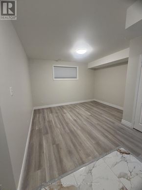 Toronto (Malvern) apartment for rent - A room with wooden flooring and a window.