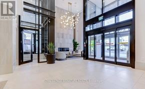 Toronto (Humewood-Cedarvale) condo for rent - A modern lobby with a chandelier and a plant in a pot.
