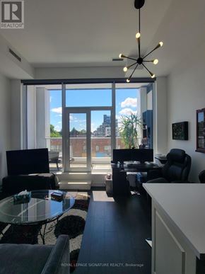 Toronto (Humewood-Cedarvale) condo for rent - A well-lit living room with a glass table and a ceiling fan.