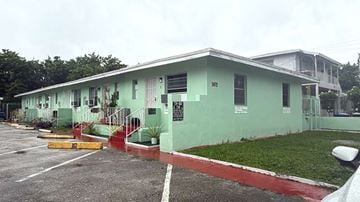 Miami apartment for rent - A green building with the number 107 on it.