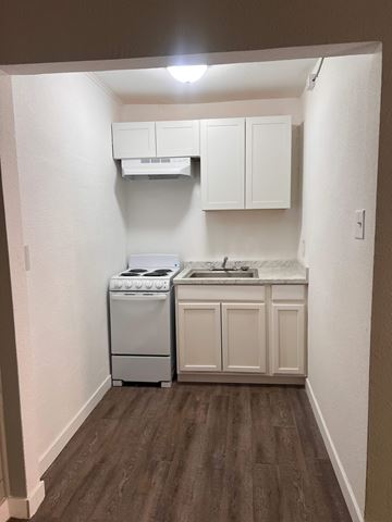 Las Vegas apartment for rent - A small kitchen with a white dishwasher and a white oven.