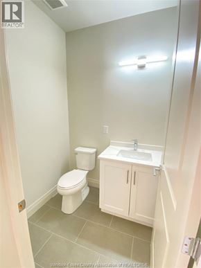 Windsor condo for rent - A white toilet and sink in a small bathroom.