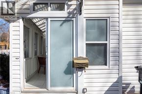 Kitchener apartment for rent - A white house with a glass door and a window.