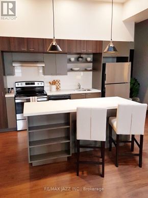 Oshawa (O'neill) multi-family for rent - A modern kitchen with a dining table and chairs.