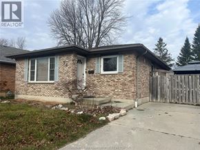 Chatham apartment for rent - A house with a brown brick exterior and a white door is shown.
