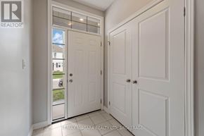 Welland (Welland Downtown) apartment for rent - A white door with a glass window is open, leading to a balcony with a view of the outside.