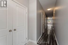 Welland (Welland Downtown) apartment for rent - A long hallway with white doors and a wooden floor.