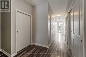 Welland (Welland Downtown) apartment for rent - A hallway with white doors and a wooden floor.