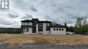Lake Of Bays (Franklin) apartment for rent - A modern house with a grey and black exterior is under construction with a car parked in front.