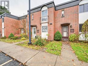Niagara Falls (Stamford) townhouse for rent - A brick house with a brown door and a small front yard.