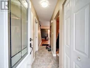 Niagara Falls (Stamford) townhouse for rent - A hallway with a glass door on the left and a white door on the right.