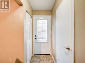 Niagara Falls (Stamford) townhouse for rent - A hallway with a white door and a window.