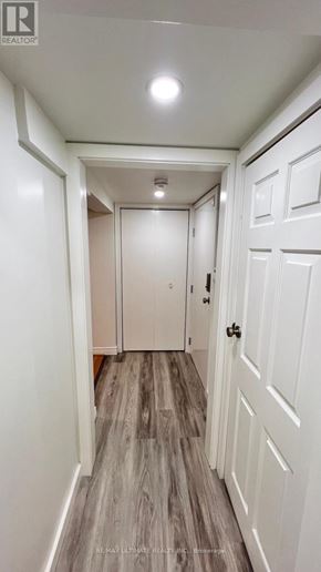 Toronto (O'connor-Parkview) apartment for rent - A hallway with white doors and a wooden floor.