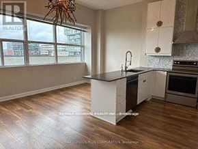 Toronto (Niagara) condo for rent - A kitchen with a large island and wooden floors.
